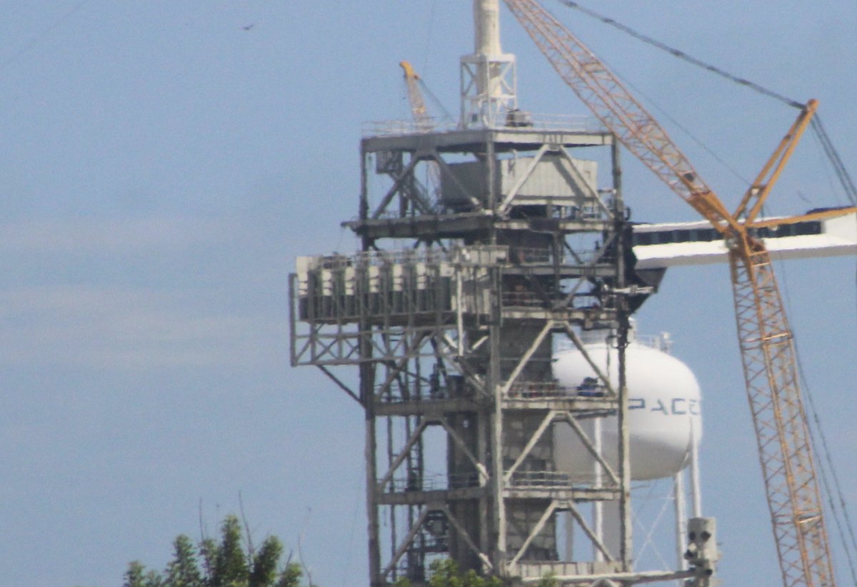 SpaceX is installing the emergency egress system that the Astronauts would use to leave the pad in an emergency. It's a slide wire system like the Space Shuttle used.