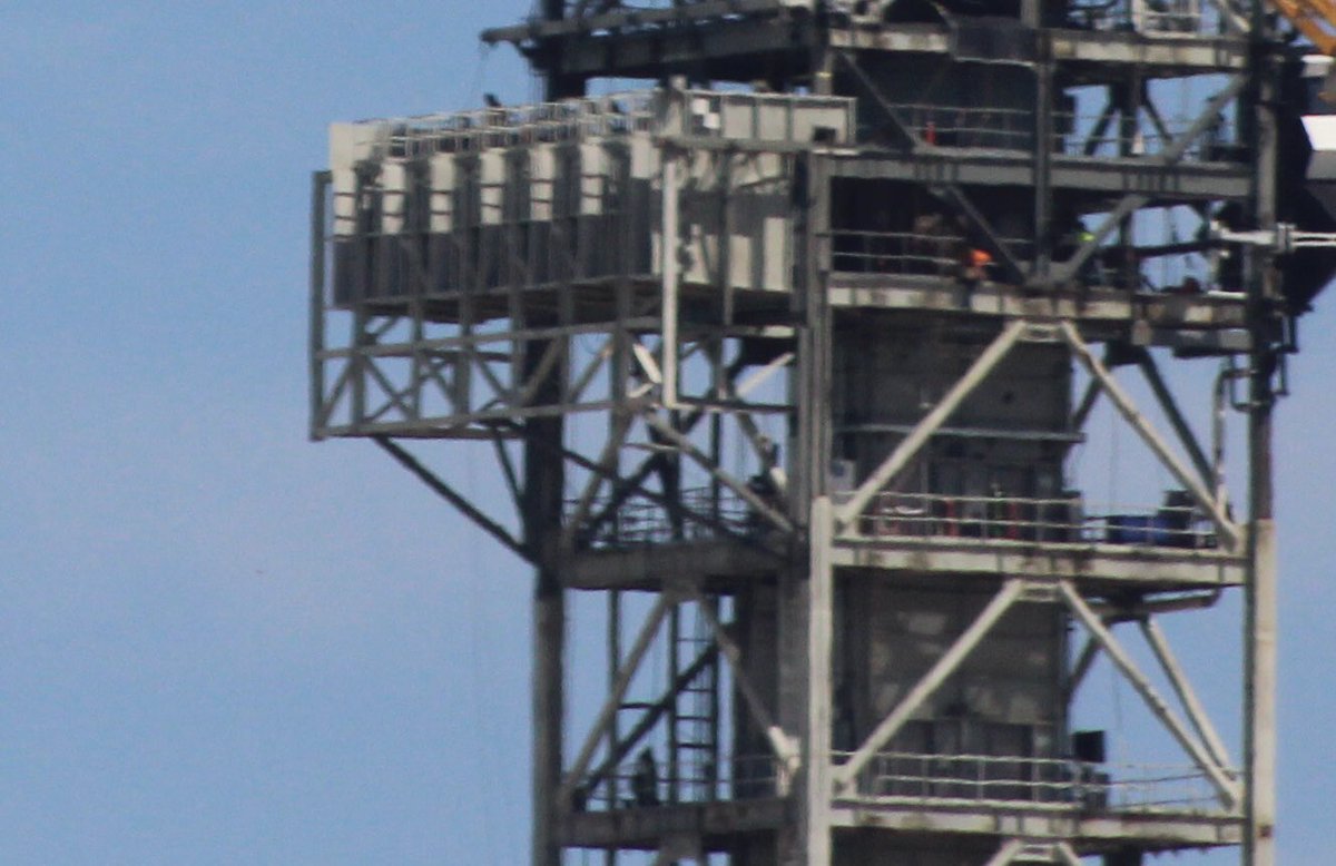 SpaceX is installing the emergency egress system that the Astronauts would use to leave the pad in an emergency. It's a slide wire system like the Space Shuttle used.