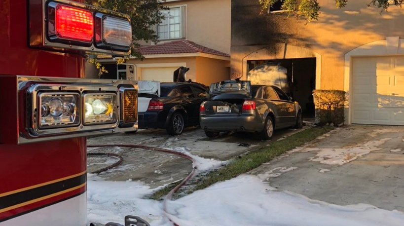 Firefighters battled two cars on fire Monday night near a Lake Worth home