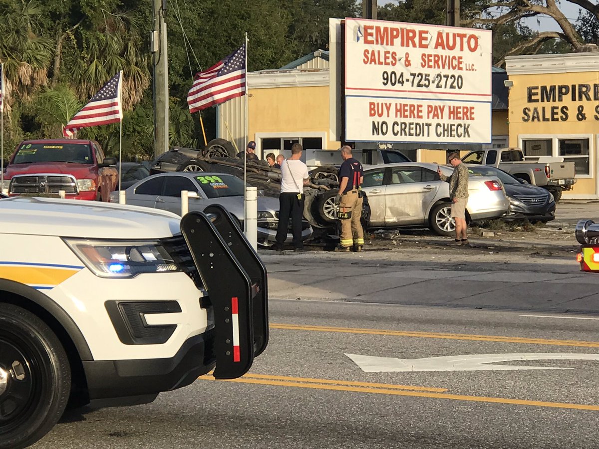 Scene of a flipped car in the lot of Empire Auto on Beach Blvd. One person has been removed from the car.