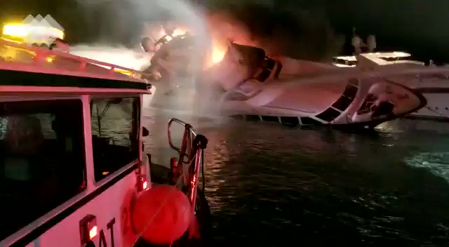 City of MiamiFire and  MiamiDadeFire boats battle blaze as yacht tilts to its side.