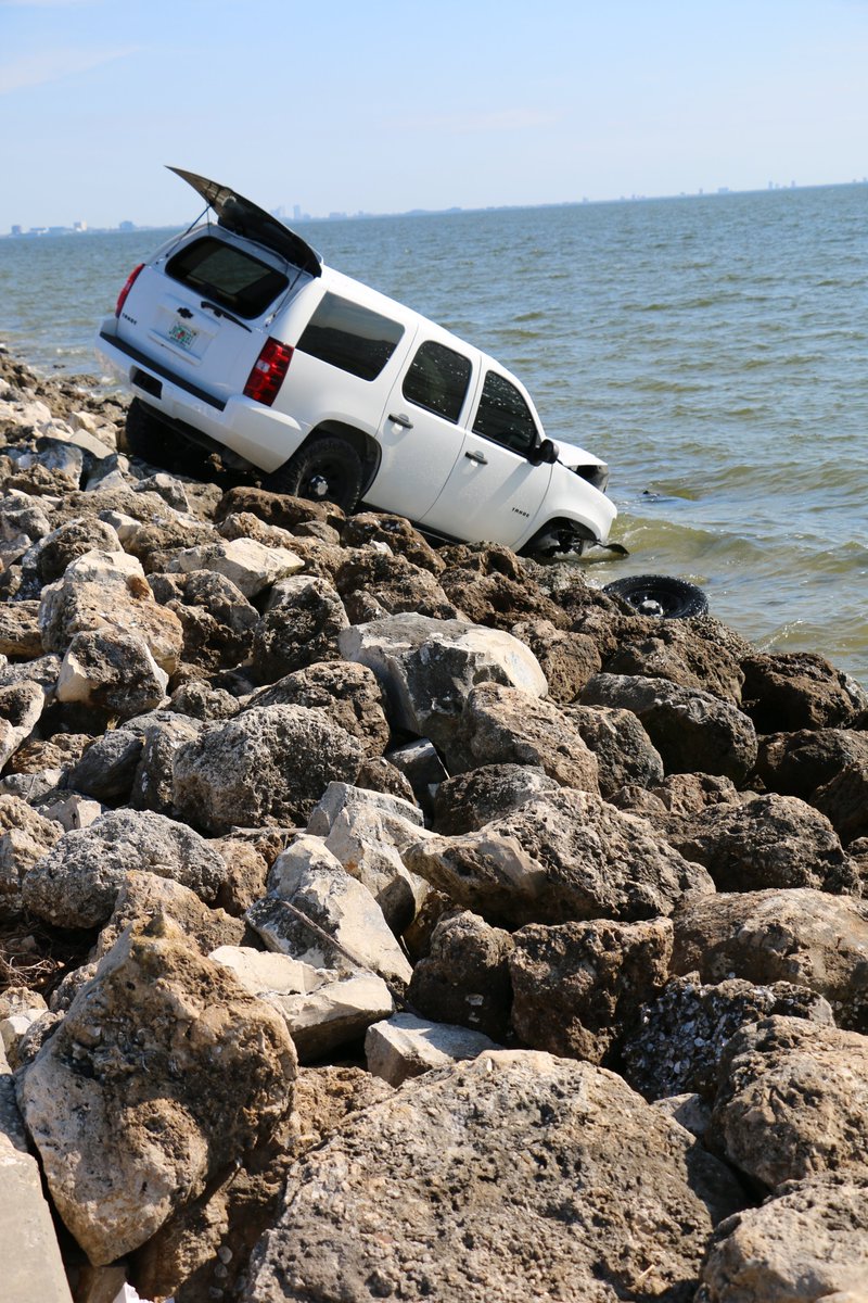 The driver of this Tahoe was cited for careless driving after veering off the Courtney Campbell Causeway and ending up in a precarious perch on the rocks and partially in the waters of Old Tampa Bay