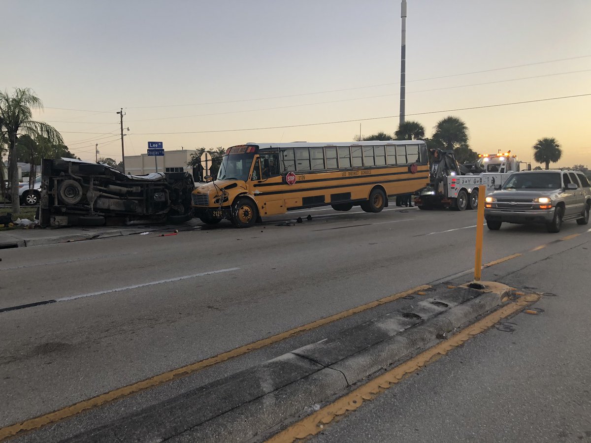Tow truck getting ready to take a school bus off the road