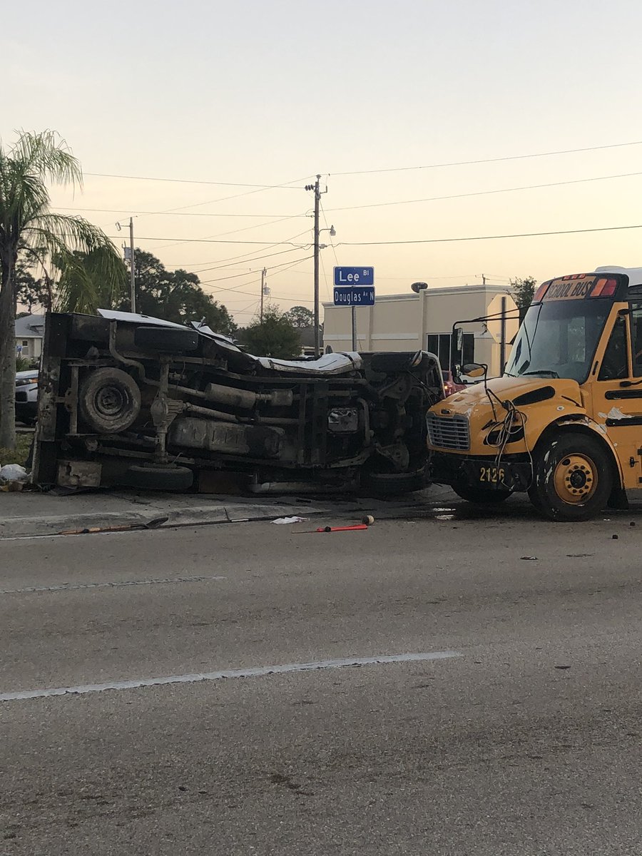 Tow truck getting ready to take a school bus off the road