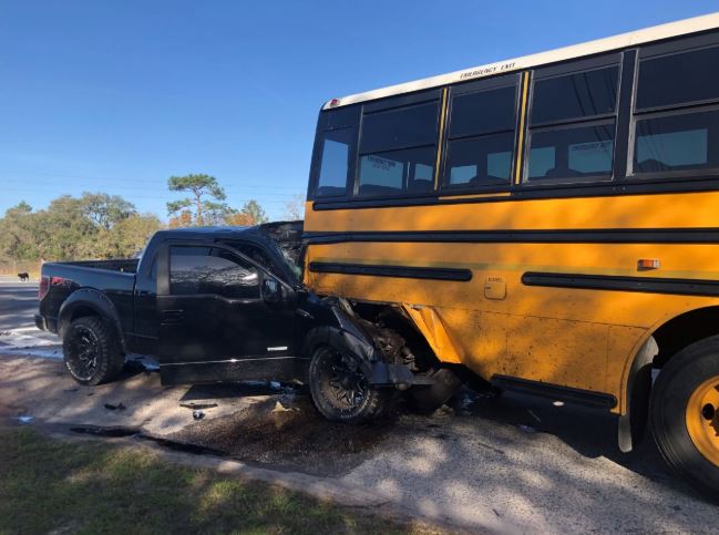 Driver of pick up dead after slamming into back of school bus in Brooksville area, FHP says. 48 kids on bus. 6 taken to area hospitals to be checked out. 