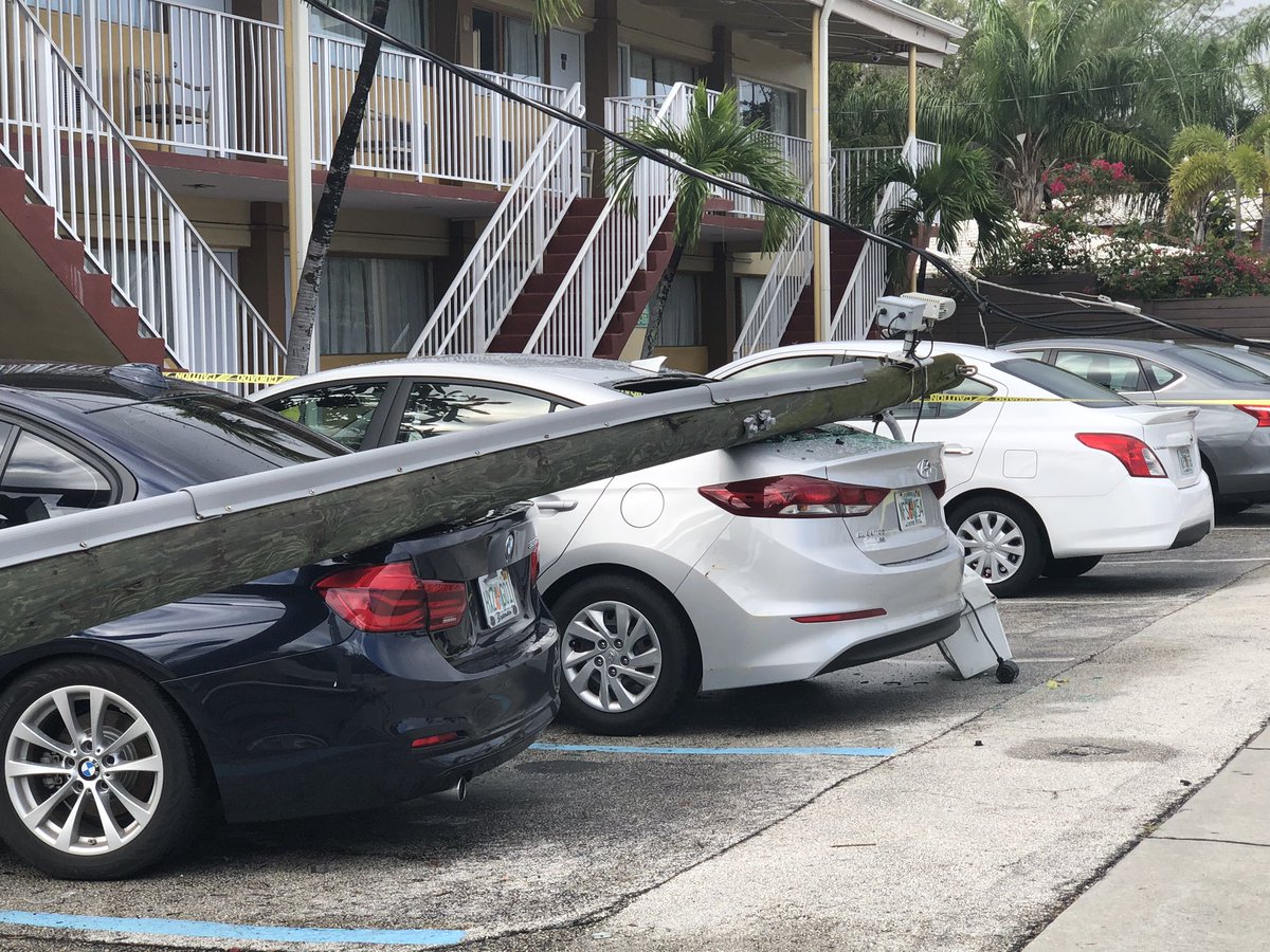 Noticed this scene while driving down Biscayne Blvd. . A light pole fell onto cars parked at the Sinbad Motel. Strong winds last night
