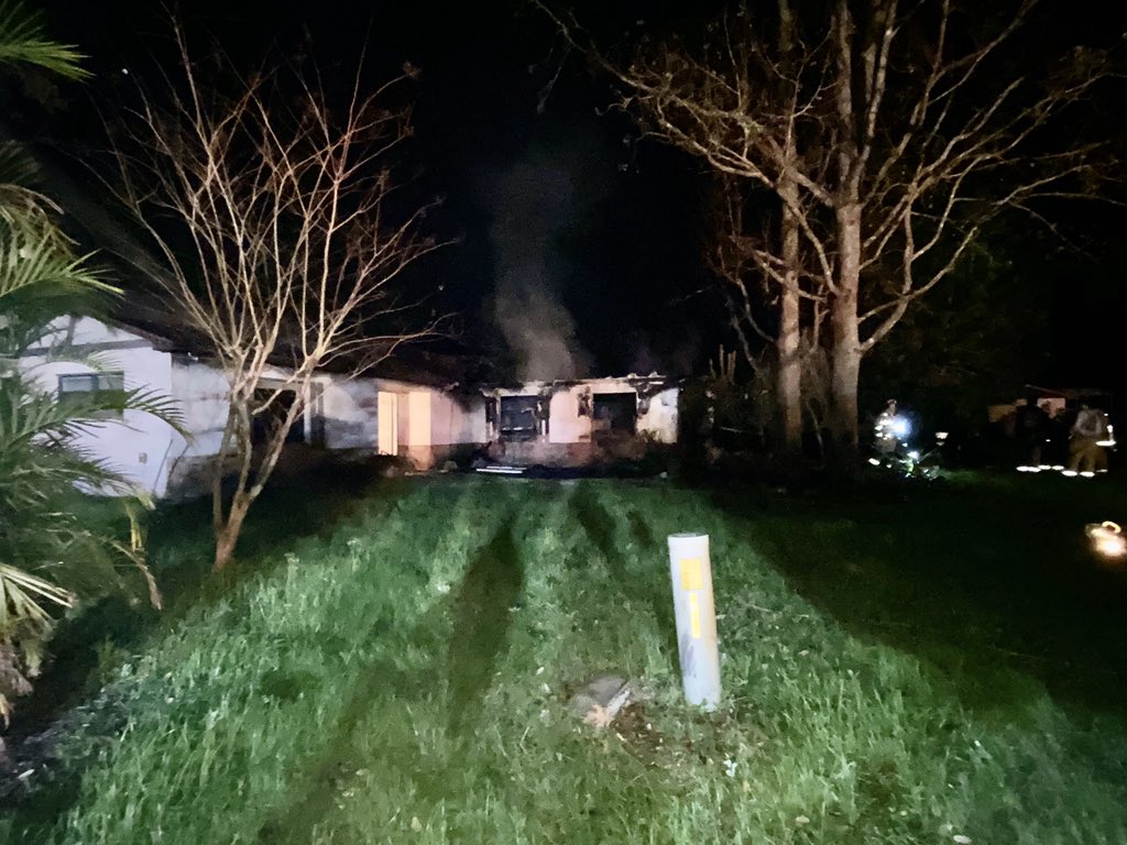 Firefighters arrive to put out a house fire in Apopka, but found no fire hydrant. They had to fill up tanks at a Wawa a mile away. Two adults & 5 dogs are ok. Cause under investigation but started in garage where some hunting ammunition began exploding during blaze 
