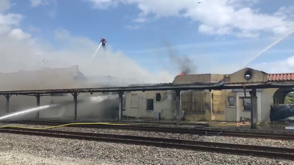 The roof is   completely gone. Little flame spots still coming out.