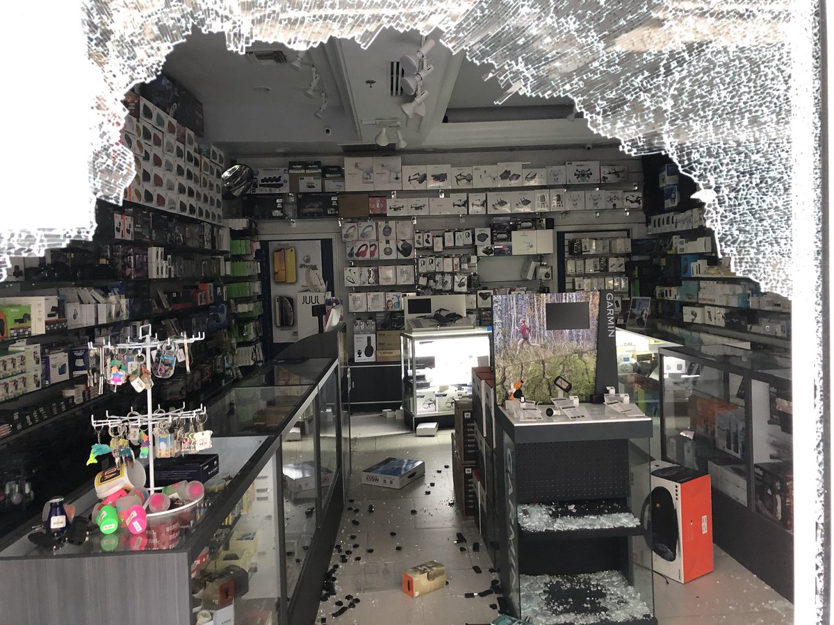Multiple stores burglarized and vandalized at Bayside Marketplace during protests. Windows smashed here at Times Square Electronics and Lacoste. Miami police standing guard. Mall is closed. Stores just reopening after COVID19 closures