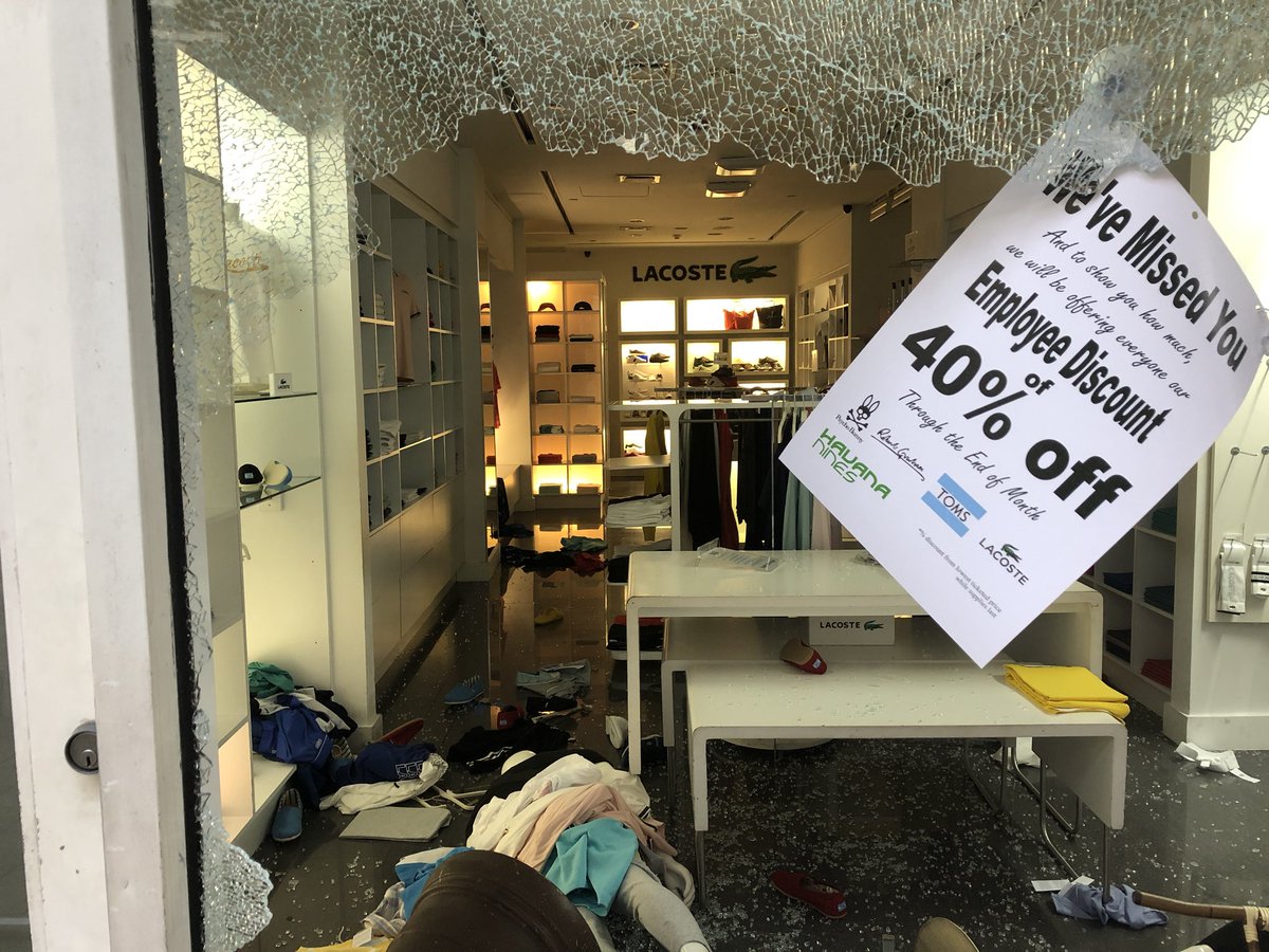 Multiple stores burglarized and vandalized at Bayside Marketplace during protests. Windows smashed here at Times Square Electronics and Lacoste. Miami police standing guard. Mall is closed. Stores just reopening after COVID19 closures