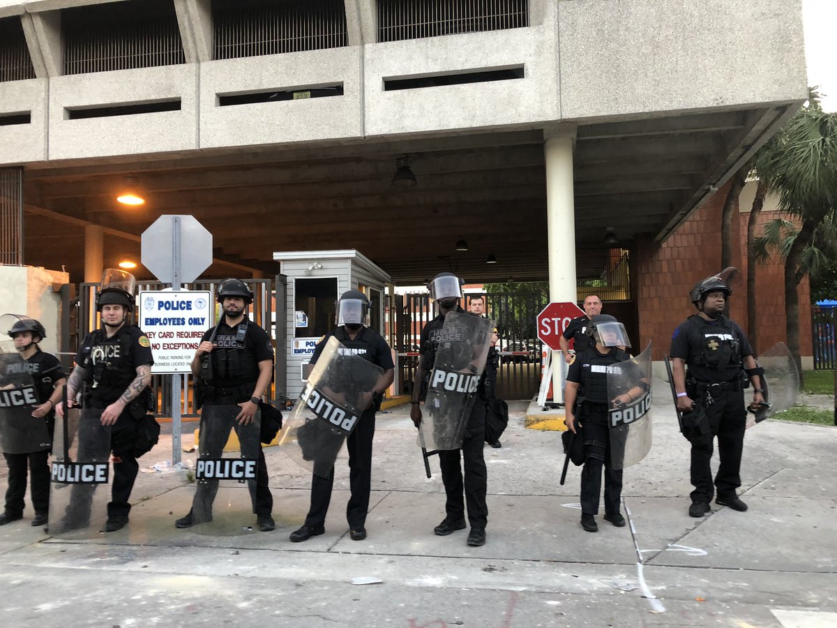 On Sunday morning, about a dozen Miami police with shields and helmets outside city police station that was site of protests Saturday night