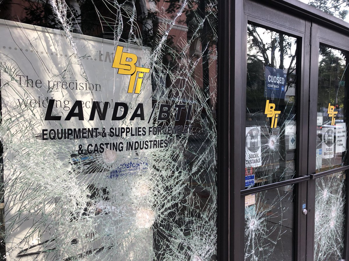 Smashed windows at jewelry stores and offices on Miami's NE 1st Avenue, as Miami's coronavirus emergency overlaps with a night of unrest