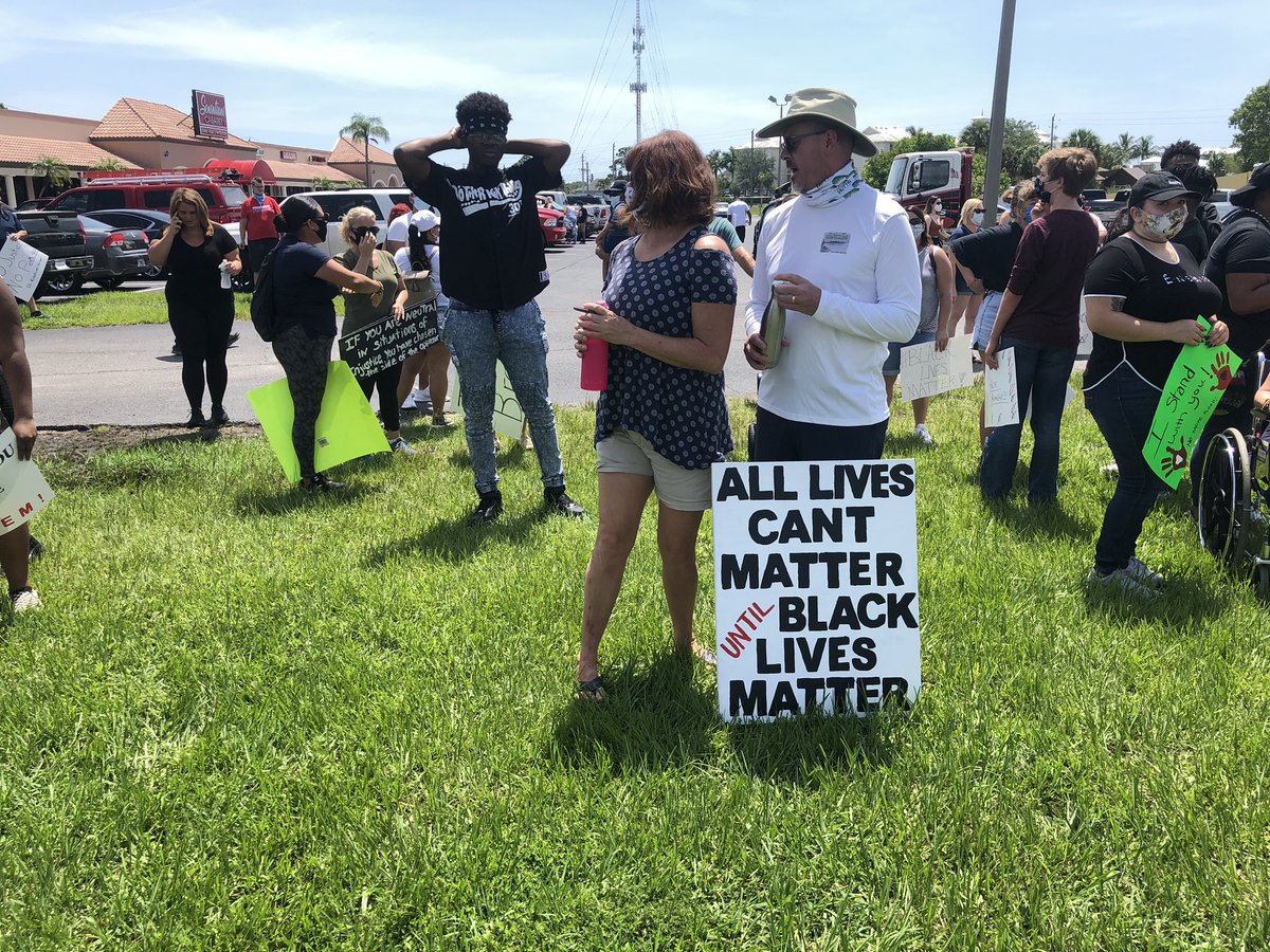 Protesters gather near the base of the Roosevelt Bridge in Stuart. Walk will begin at noon