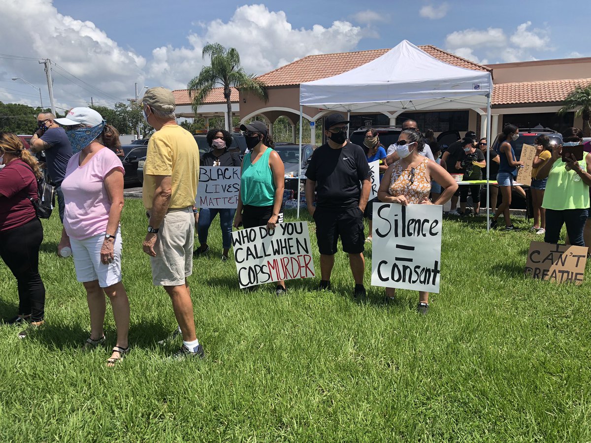 Protesters gather near the base of the Roosevelt Bridge in Stuart. Walk will begin at noon
