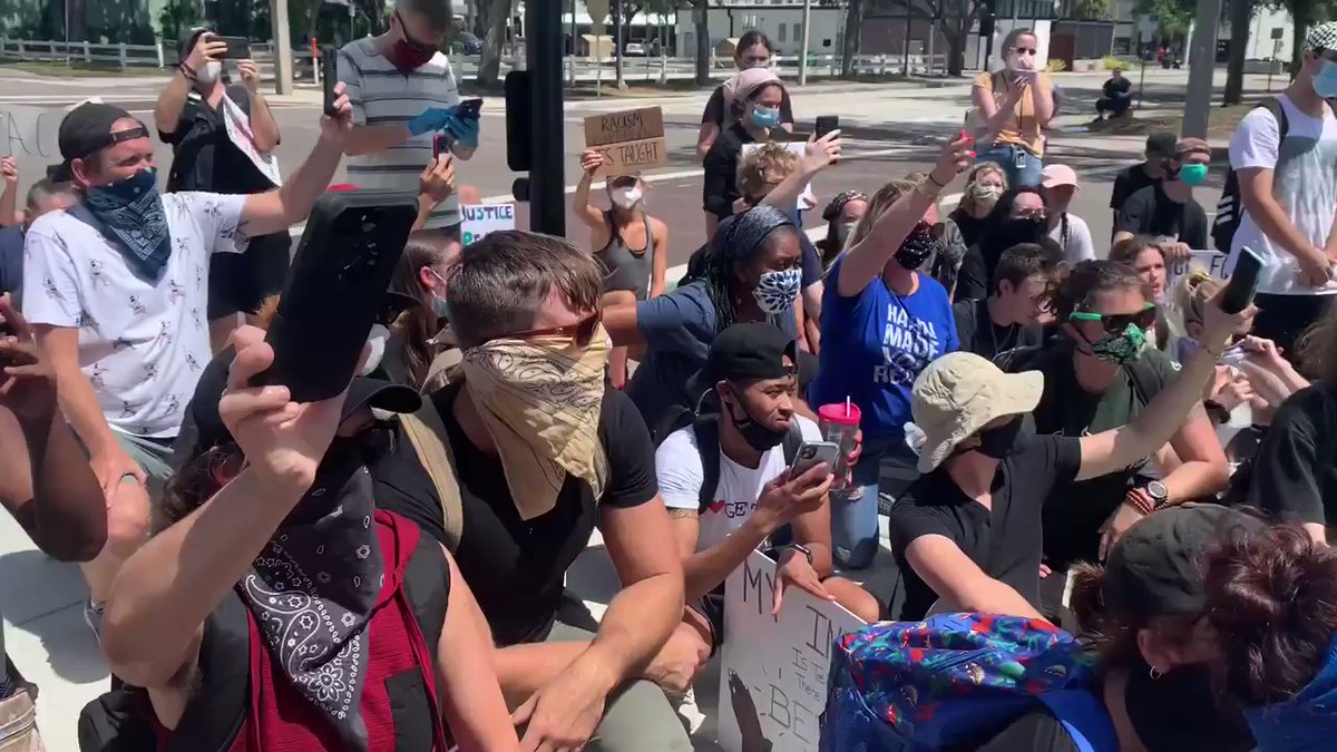 Right   protesters marching through St. Pete. They stopped at police headquarters- met by the chief and mayor who knelt with them. 