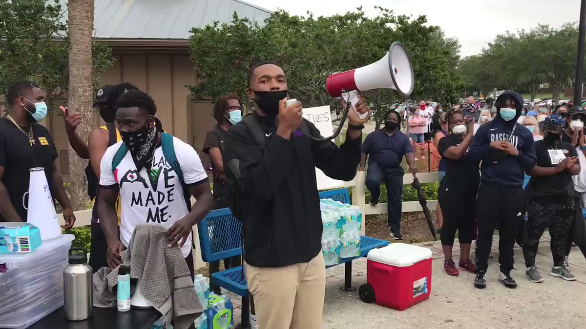 R.J. Rogers, one of the organizers of today's protest at Waterfront Park in Clermont addresses the growing crowd before event starts at 3. Maybe 150 to 200 people   and growing
