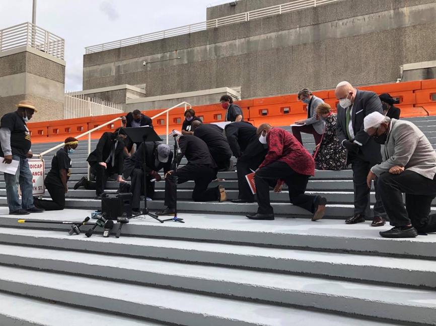 Faith leaders speak out, kneel for accountability