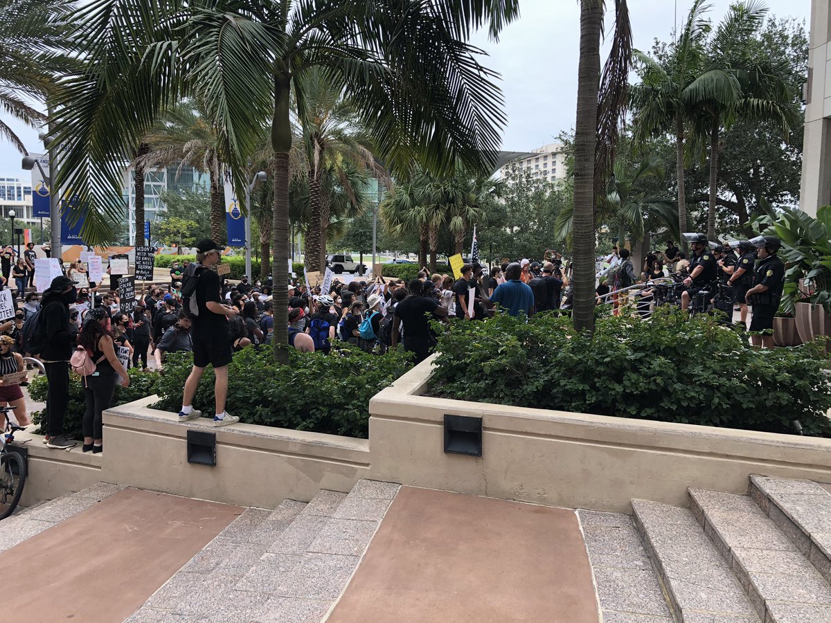 This group of a couple hundred protestors has   stopped in front of city hall, shouting and chanting to police guarding the building. 