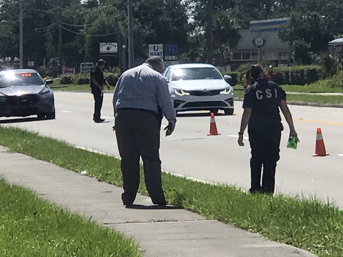 Detectives and CSI searching along University for shell casings. 