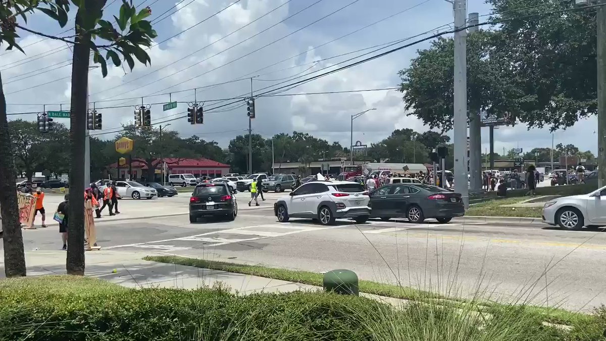 Protestors moving from intersection into street, chanting whose streets Our streets.