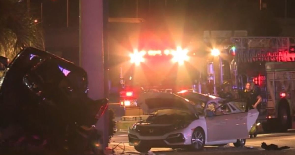 Police say an 18-year-old driver and his passenger were killed when another car ran a red light and crashed into them