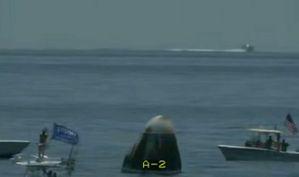 Some private vessels in the vicinity of the capsule. One waving a campaign flag