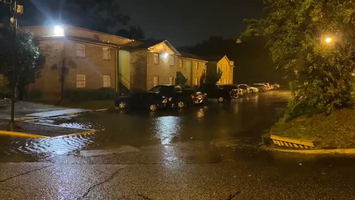 The Forest Creek Apartments parking lot is completely flooded, cars have been moved to the street. 