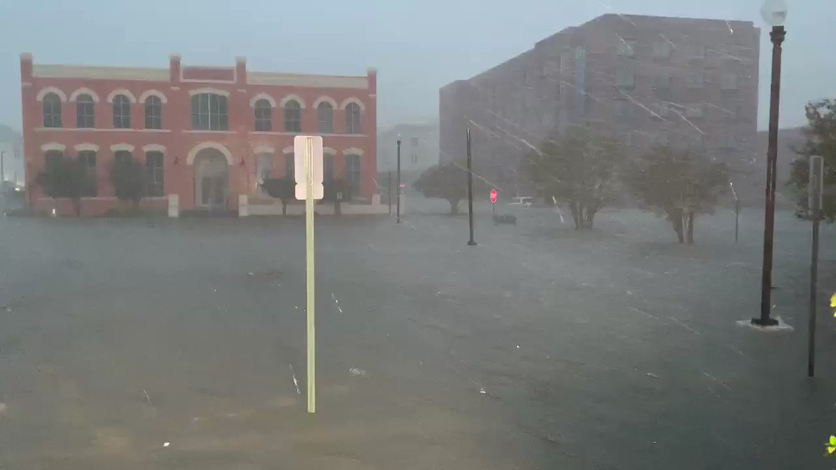 Latest rain totals at Pensacola Naval Air Station- 24.8 inches. That's per @NWSMobile.  This is the parking lot in front of our hotel downtown Pensacola- cars in the distance already have water approaching the windows