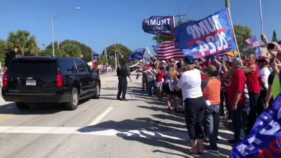 Donald Trump waives to crowd of supporters from inside an SUV in West Palm Beach