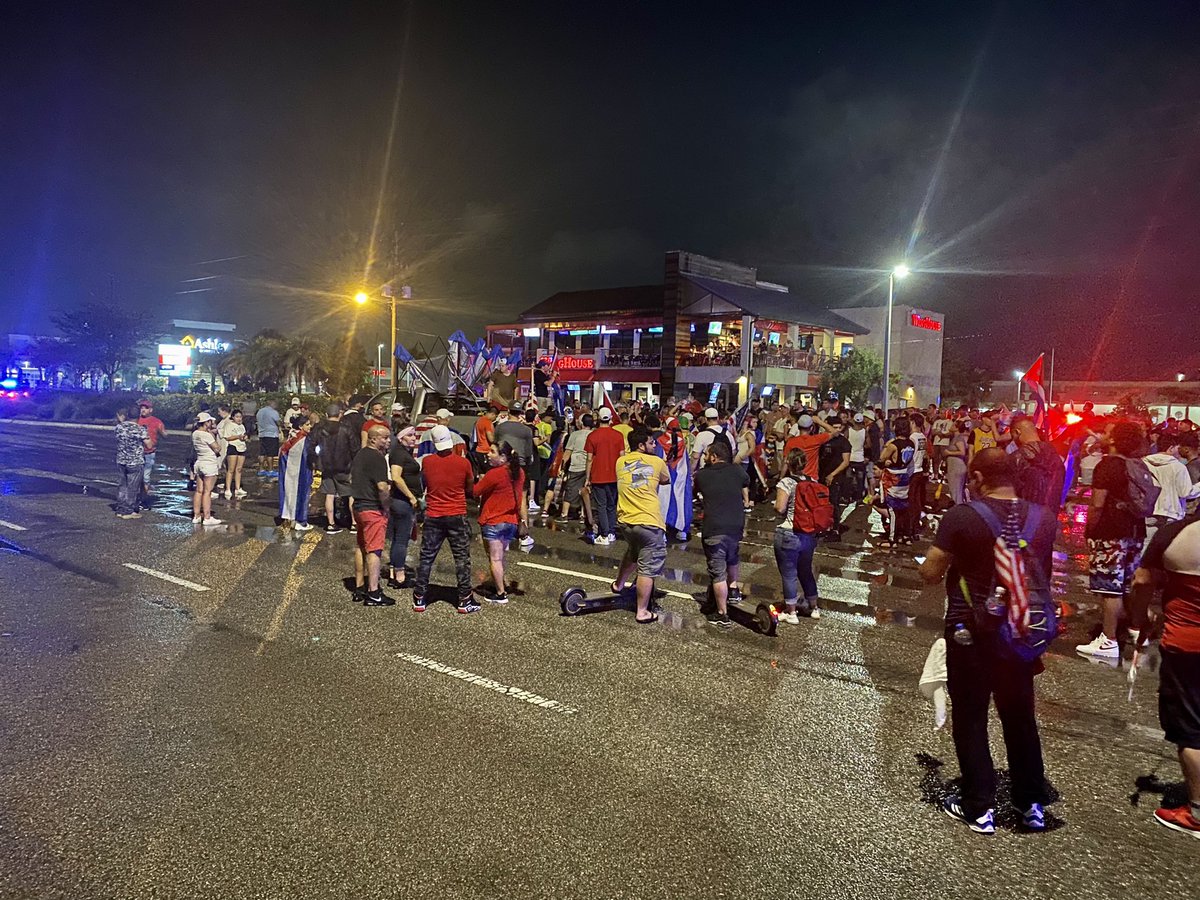 A large crowd stands in solidarity with protests in Cuba. Police closed Columbus Drive to traffic from Dale Mandy to Himes. Cuban flags, chants, and honking in this 10 pm hour