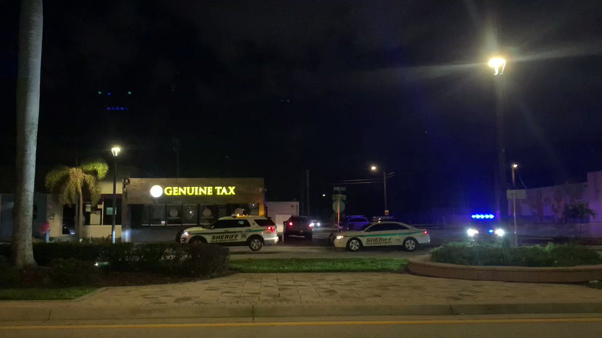 This is the scene on Dixie Hwy and 1st Ave S. There are more sheriff deputies blocking off the street across. Crime scene tape surrounding investigation area. 
