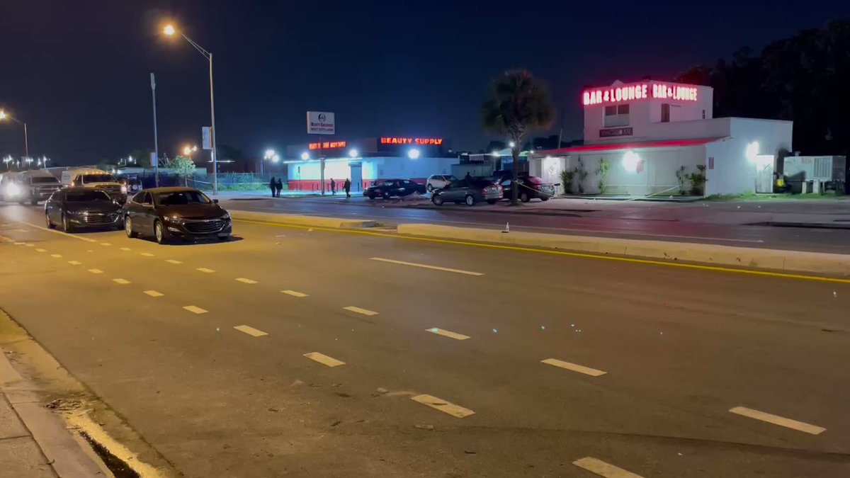 At least one person is dead after a possible shooting outside the Chicagoan Bar & Lounge in NW Dade. Body covered by tarp on ground, lying next to car that has several apparent bullet holes. Hearing there may be other victims