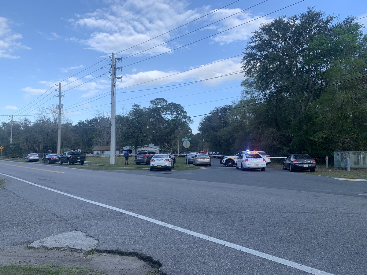 There is a very heavy law enforcement presence out here. I counted more than a dozen JSO cruisers, a crime scene unit & investigators combing the street. @wjxt4's Sky4 captured a black car riddled with bullets in the middle of this road