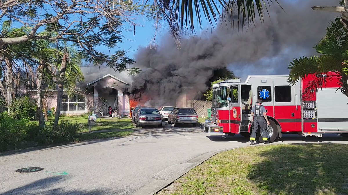 Scene from St. John's Drive in Satellite Beach as officers and firefighters arrived at this morning's house fire. Flames pouring from garage. 