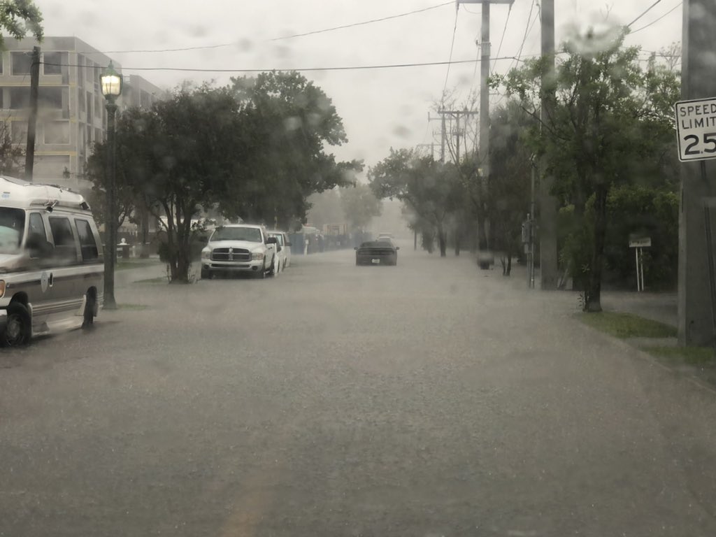 Heavy rain in West Palm Beach east of US1 causing street flooding. I'm not sure but it looks like this car may be stuck in the middle of the road from the high water