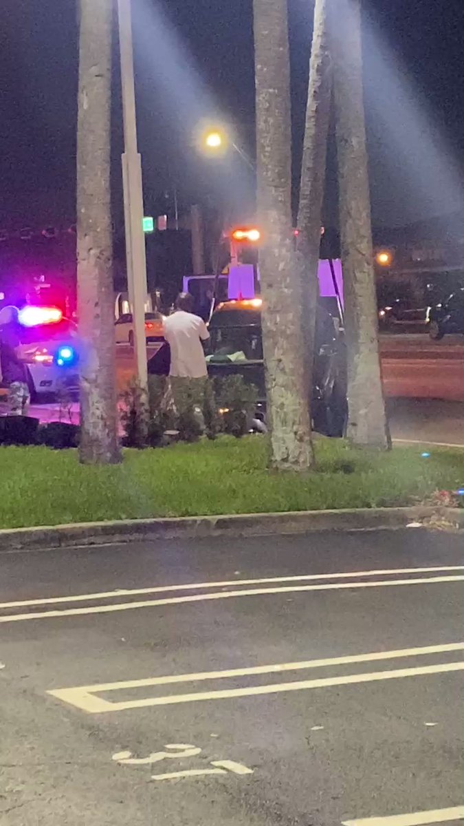 Tow truck hauling off smashed car amid investigation this morning in Miami Gardens