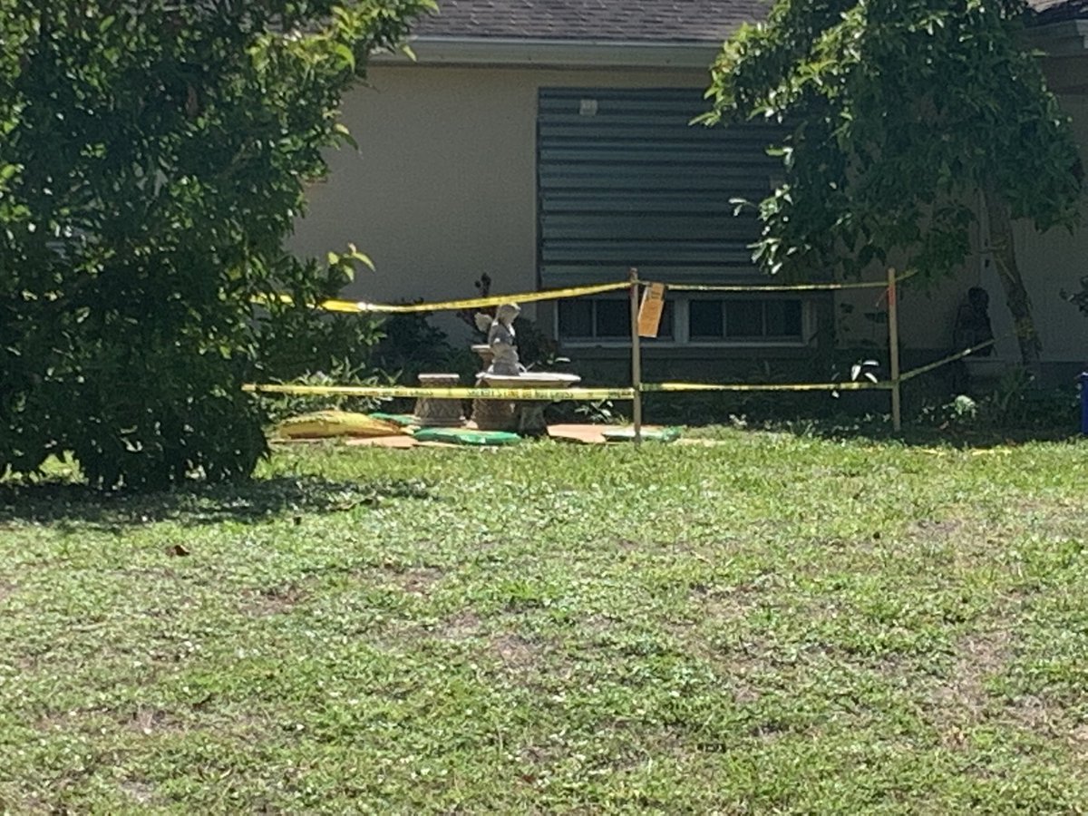 An angel statue weighs down a piece of plywood.  On Tuesday @NorthPortPolice say the body of a 74-year-old woman was found in the septic tank after what appears to be a tragic accident.