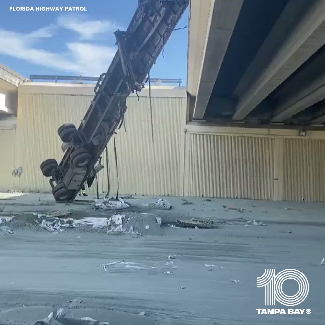 A semi-truck was left hanging off an overpass Friday morning in southwest Florida, according to the Florida Highway Patrol. There was no immediate word on any injuries