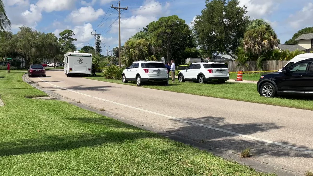 The Lee County Sheriff's Office has a portion of New Post Road near Bayshore Road blocked off with crime scene tape. There's a wall covering a portion of an area off the side of the road.