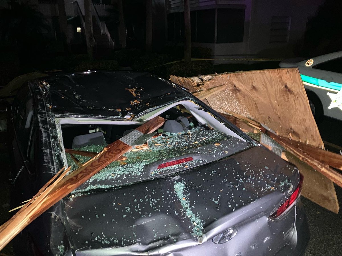 Strong winds tossed cars and knocked a tree into a building at a complex in Kings Point near Delray Beach