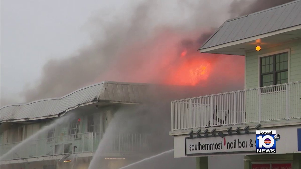 From the flooded parking lot, firefighters extinguish flames at Key West building