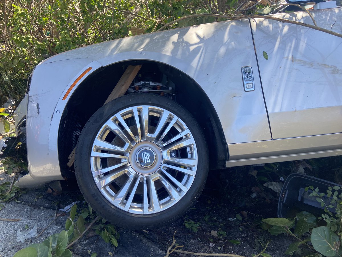 A Rolls Royce somehow ended up behind this guardrail and wedged in this tree. Also, these two boats are blocking off a section of Bonita Beach Road. There are three other boats about a quarter of a mile up the road sitting along the sidewalk