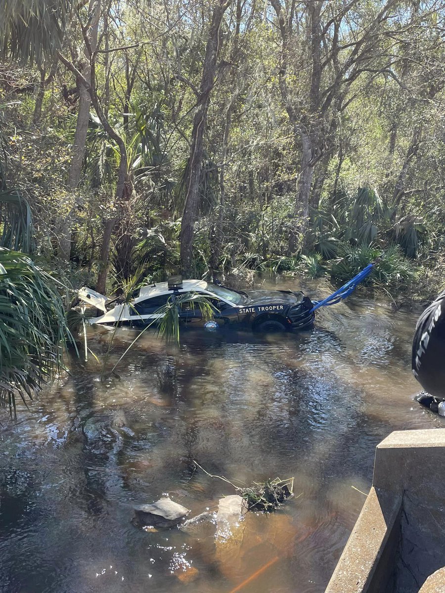 A FHP car was pulled from flood waters caused by Hurricane Ian. The trooper was able to escape through the window & swim to a tree and radio for help, when the road washed out underneath him. astonished camera: Ocala PD