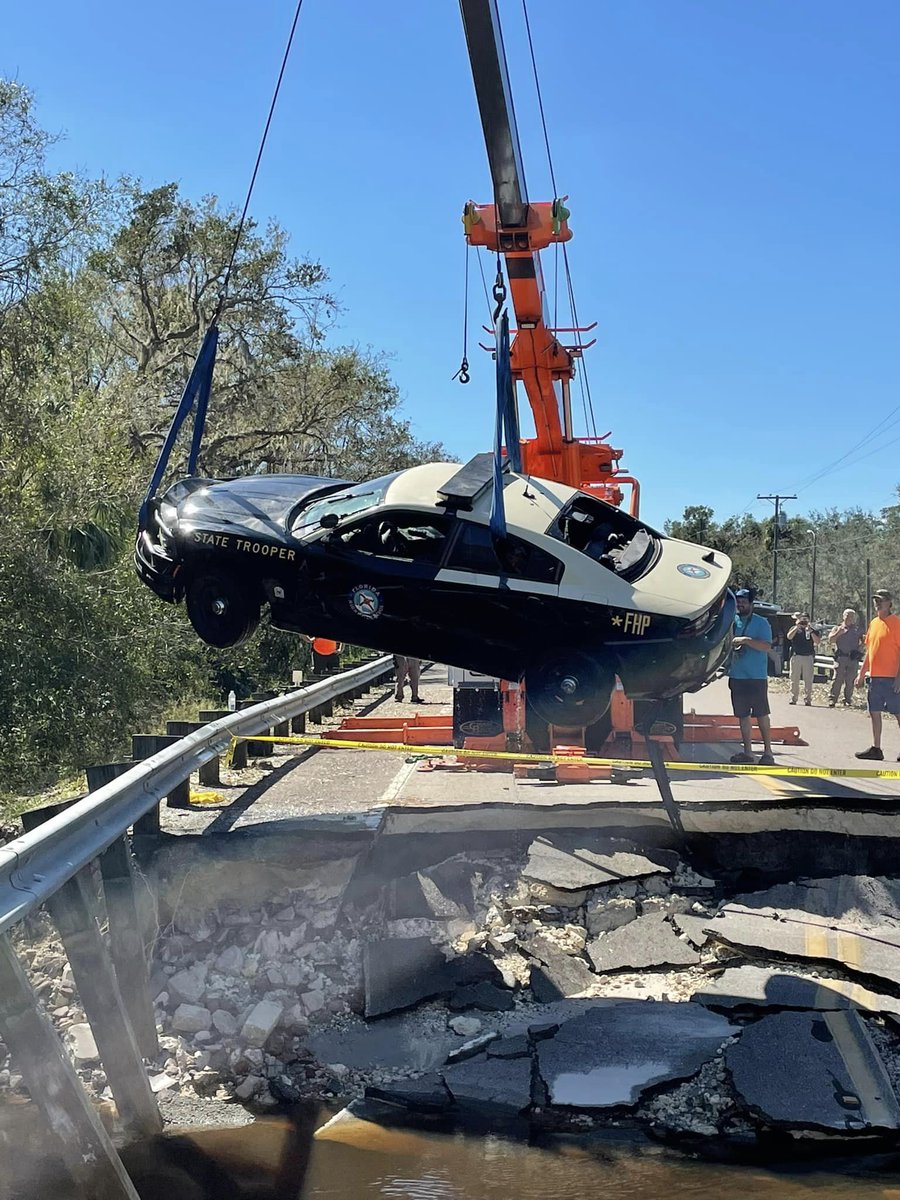 A FHP car was pulled from flood waters caused by Hurricane Ian. The trooper was able to escape through the window & swim to a tree and radio for help, when the road washed out underneath him. astonished camera: Ocala PD