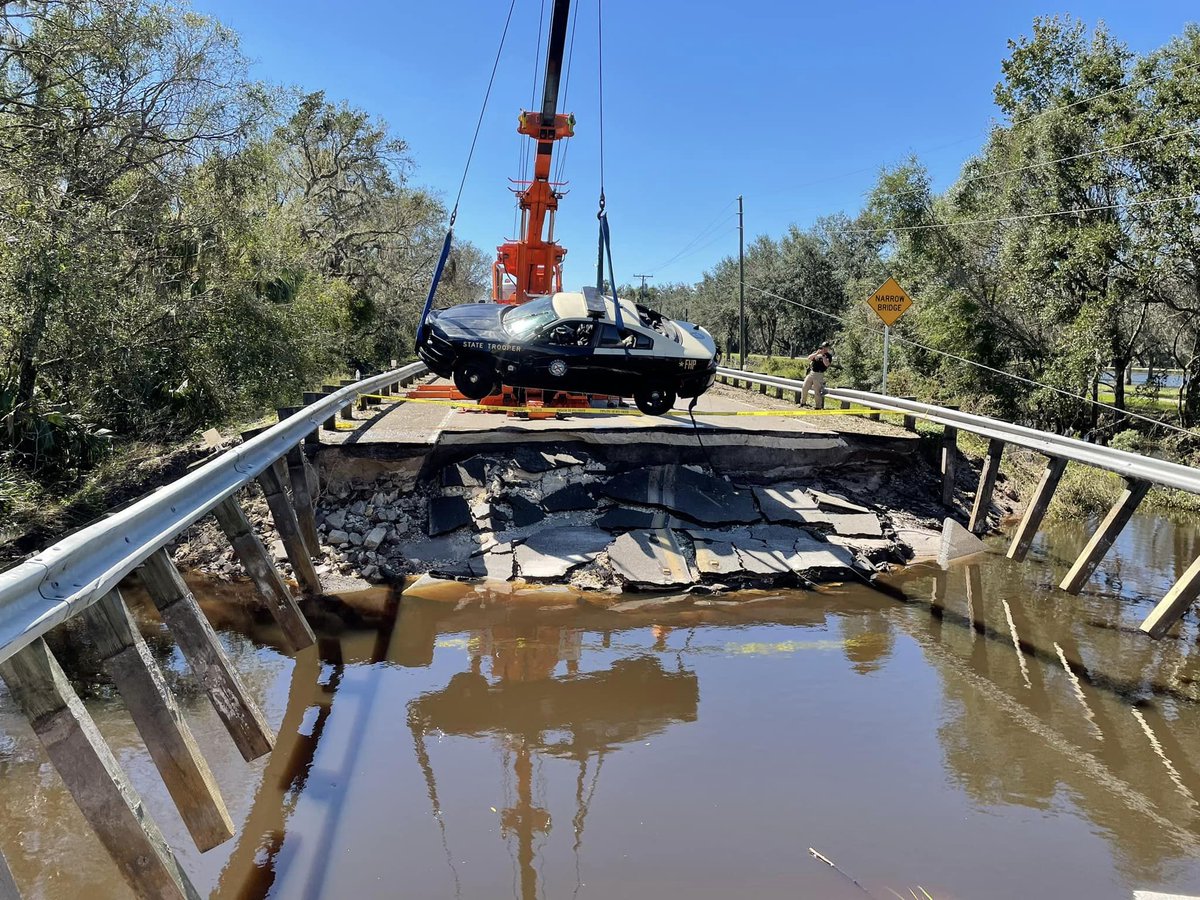 A FHP car was pulled from flood waters caused by Hurricane Ian. The trooper was able to escape through the window & swim to a tree and radio for help, when the road washed out underneath him. astonished camera: Ocala PD