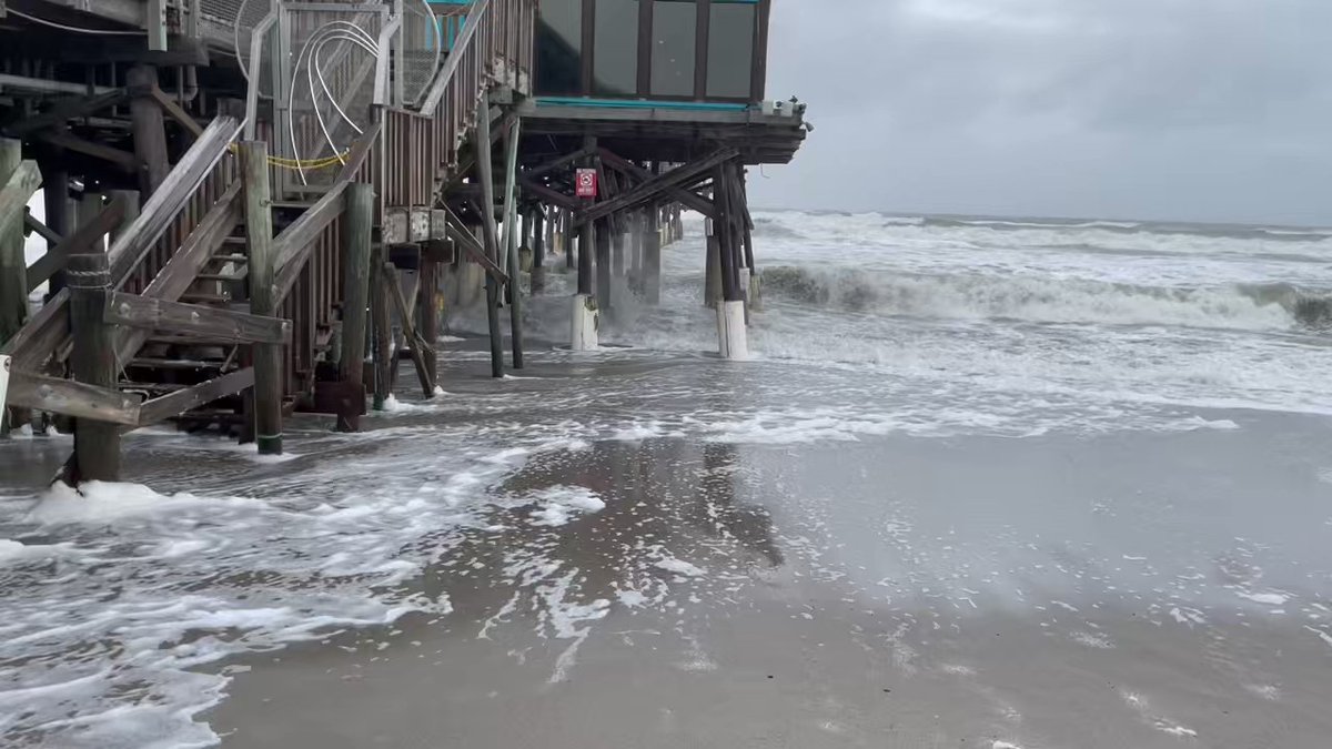 Rough surf in Cocoa Beach, just north of Nicole's expected landfall.  The pier is closed and businesses are boarded up to prepare