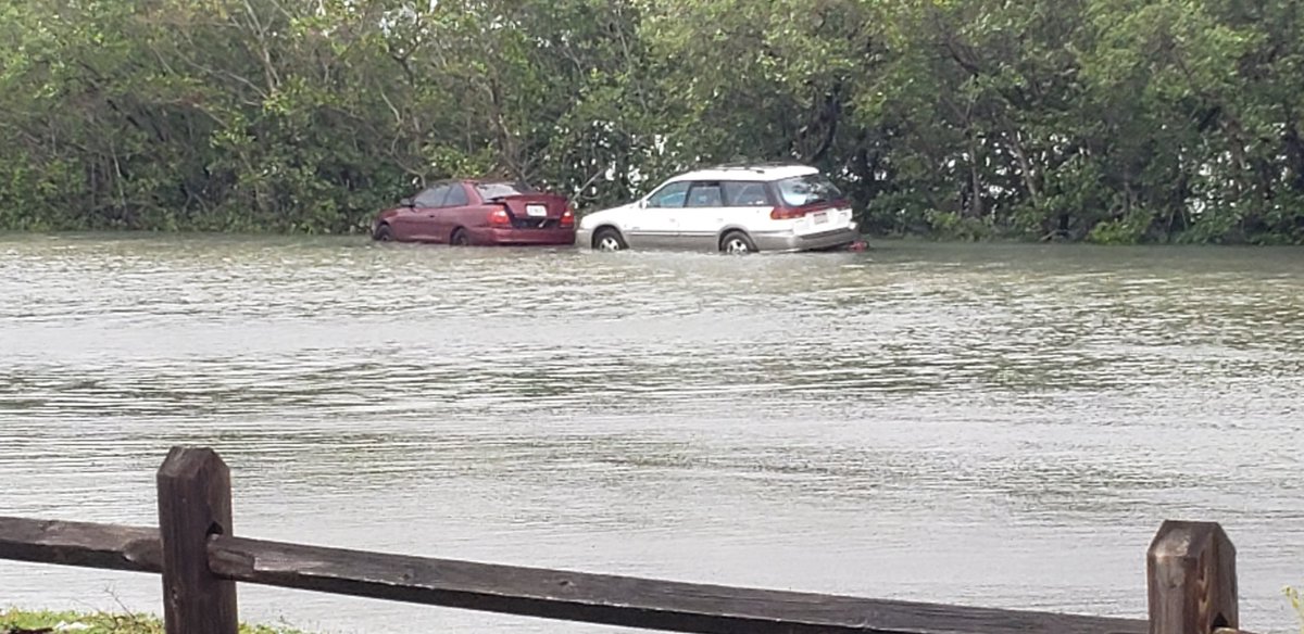 Lagoon & rainwater in parking lot at N. Causeway ramp in Fort Pierce. Cars flooded. Not sure why they were left there