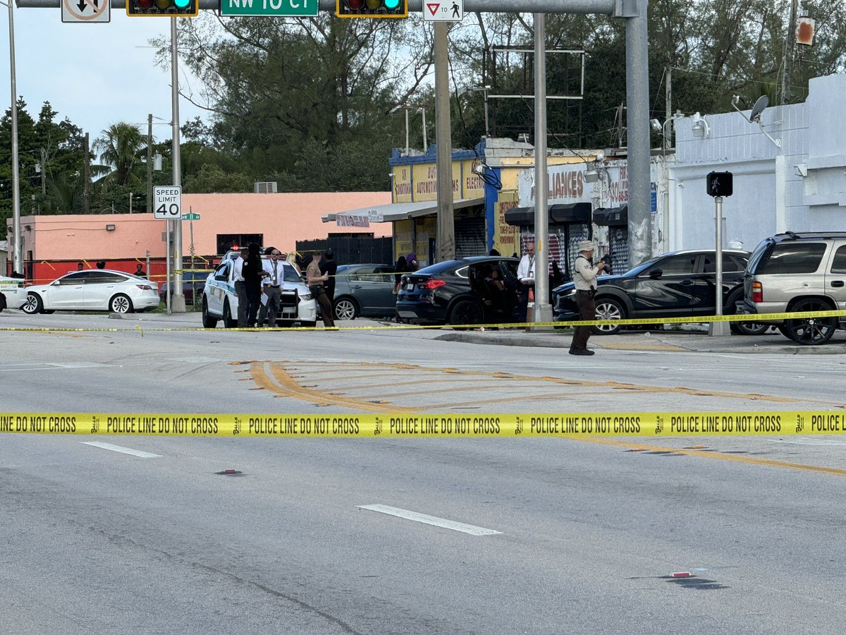 At least one person is dead after a shooting near Tropicana Bar on NW 79th St and  10th Court in Gladeview area. One body seen covered by tarp, several evidence markers on ground nearby. Police currently gathering evidence. 