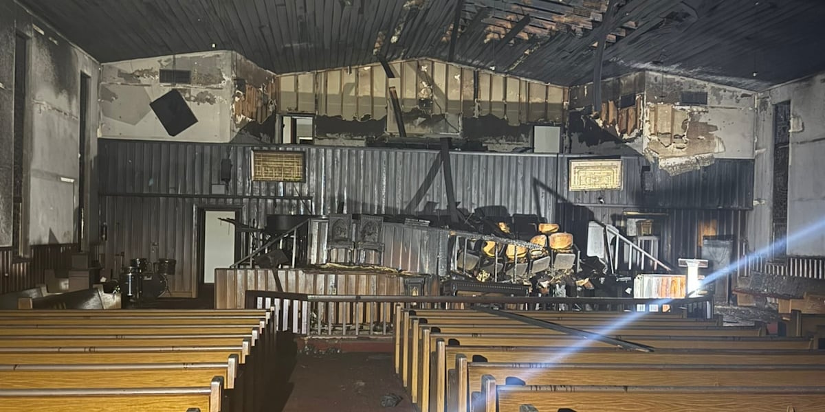 A burned church was vandalized with slurs and demonic images